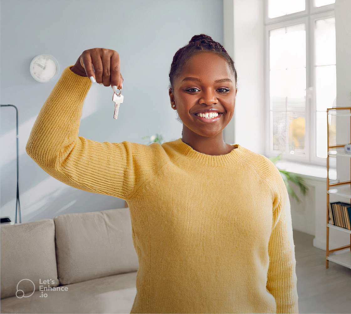 Happy home owner holding the keys to her apartment